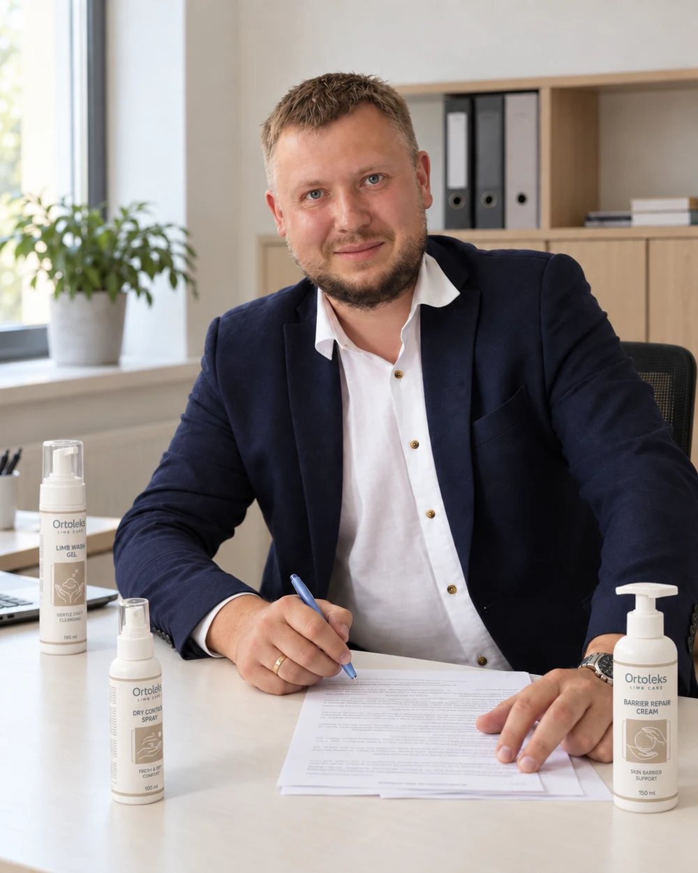 Sergei Kozeev at his desk with ORTOLEKS product samples